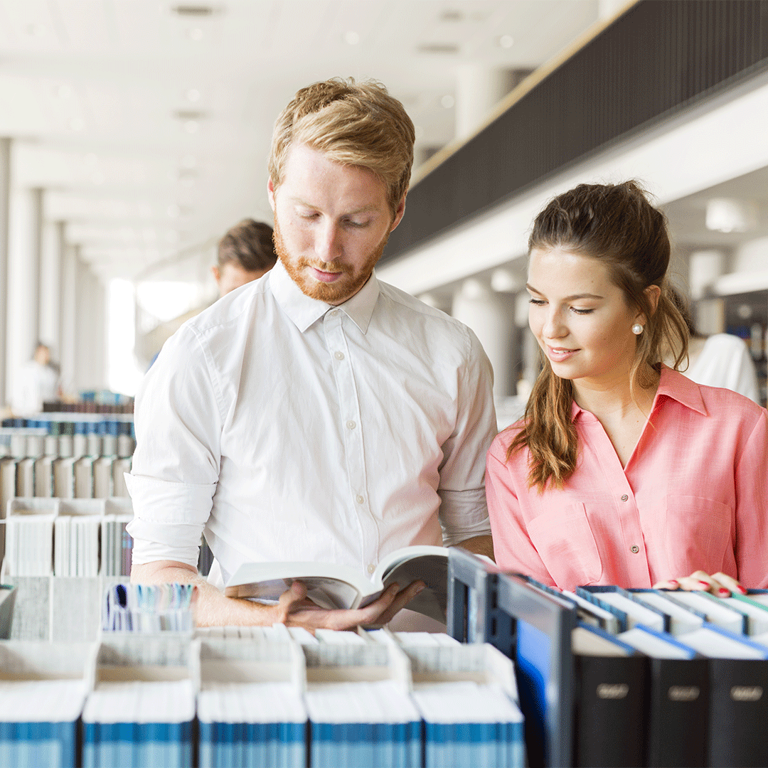 two-students-reading-and-studying-in-library